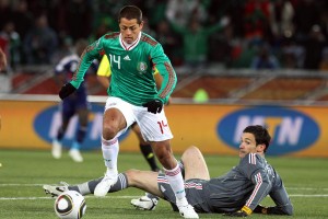 Javier Hernandez of Mexico rounds Hugo Lloris goalkeeper of France to score the opening goal against France