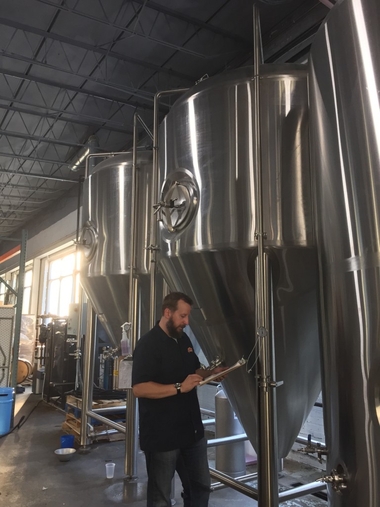 Dan checks in on the brewery's two forty-gallon fermenters.
