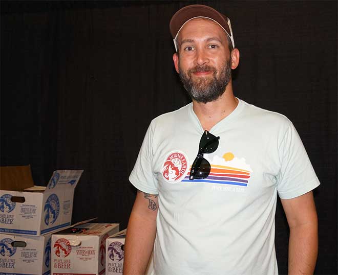 Mother Earth Brewing rep poses for photo at beer booth