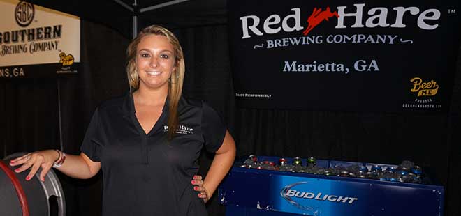 Red Hare Brewing rep poses for photo at beer booth