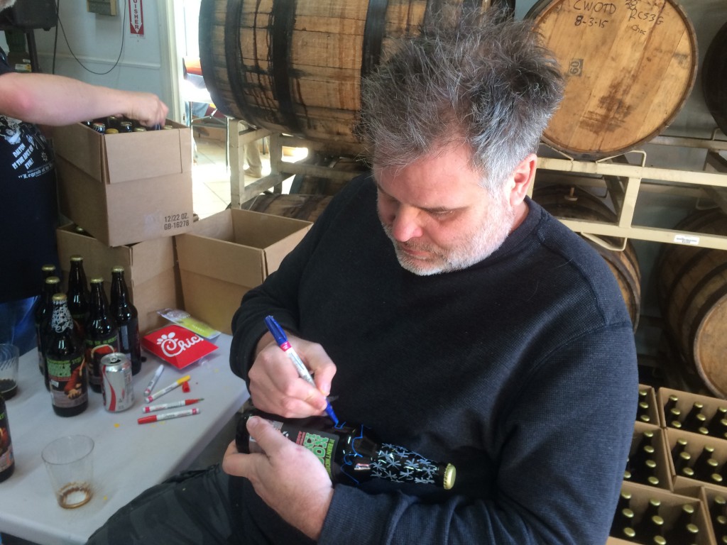 Owner Scott Hedeen signing bottles