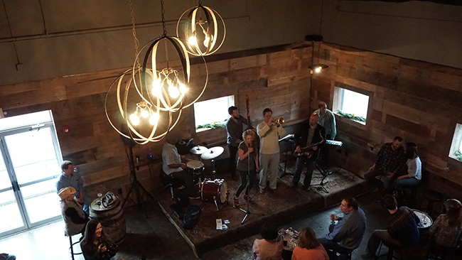 Susie Spear Purcell sings with Joe Grandsen and band during the Three Taverns Holiday Party and Bourbon Barrel Aged Feest Noel release. (Chris Powell/PorchDrinking.com)