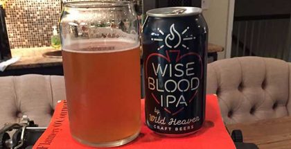 Wild Heaven Wise Blood IPA can and glass atop orange O'Connor novel