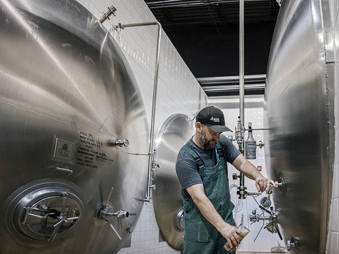 Beirstadt Lagerhaus co-head brewer and owner, Bill Eye pours a pint from a Lager tank in the brewer's cellars.