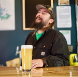 Adam Kandle laughs behind the bar at Adamant Brewing and Blending, his new brewery in North Boulder, on Wednesday, March 20, 2019. Adamant Brewing & Blending Opens in Boulder’s Former Cellar West