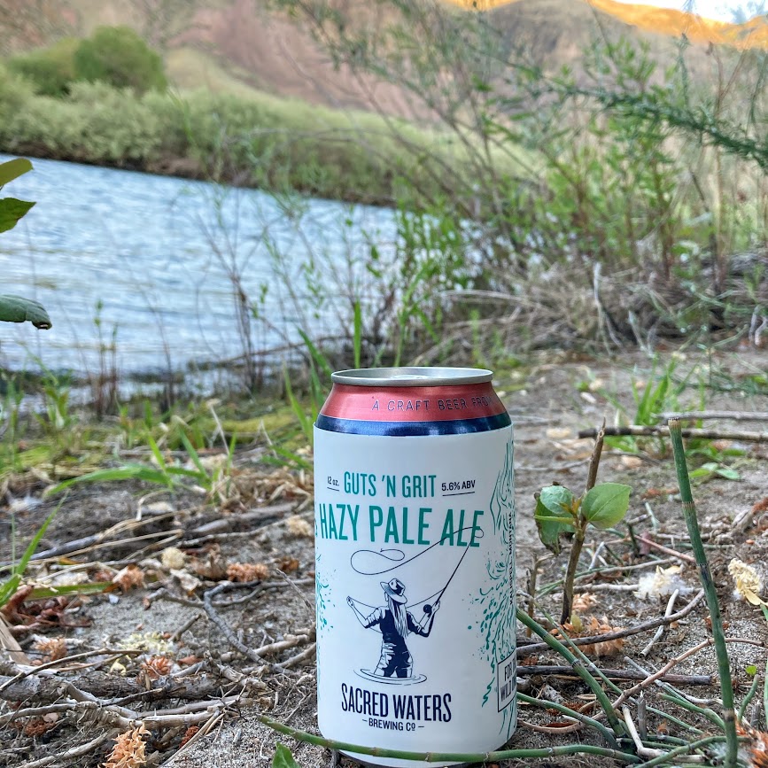 Guts N Grits Pale Ale can by a river