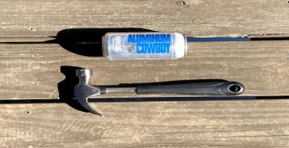 A can of Aluminum Cowboy beer lying next to a hammer