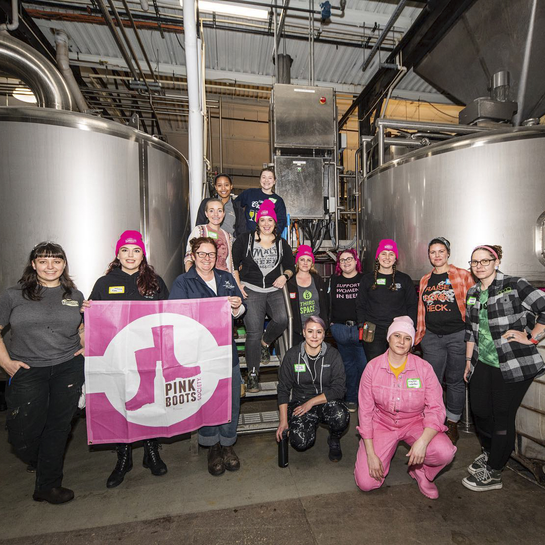 A large group of awesome women poses on the brewhouse at Third Space Brewing