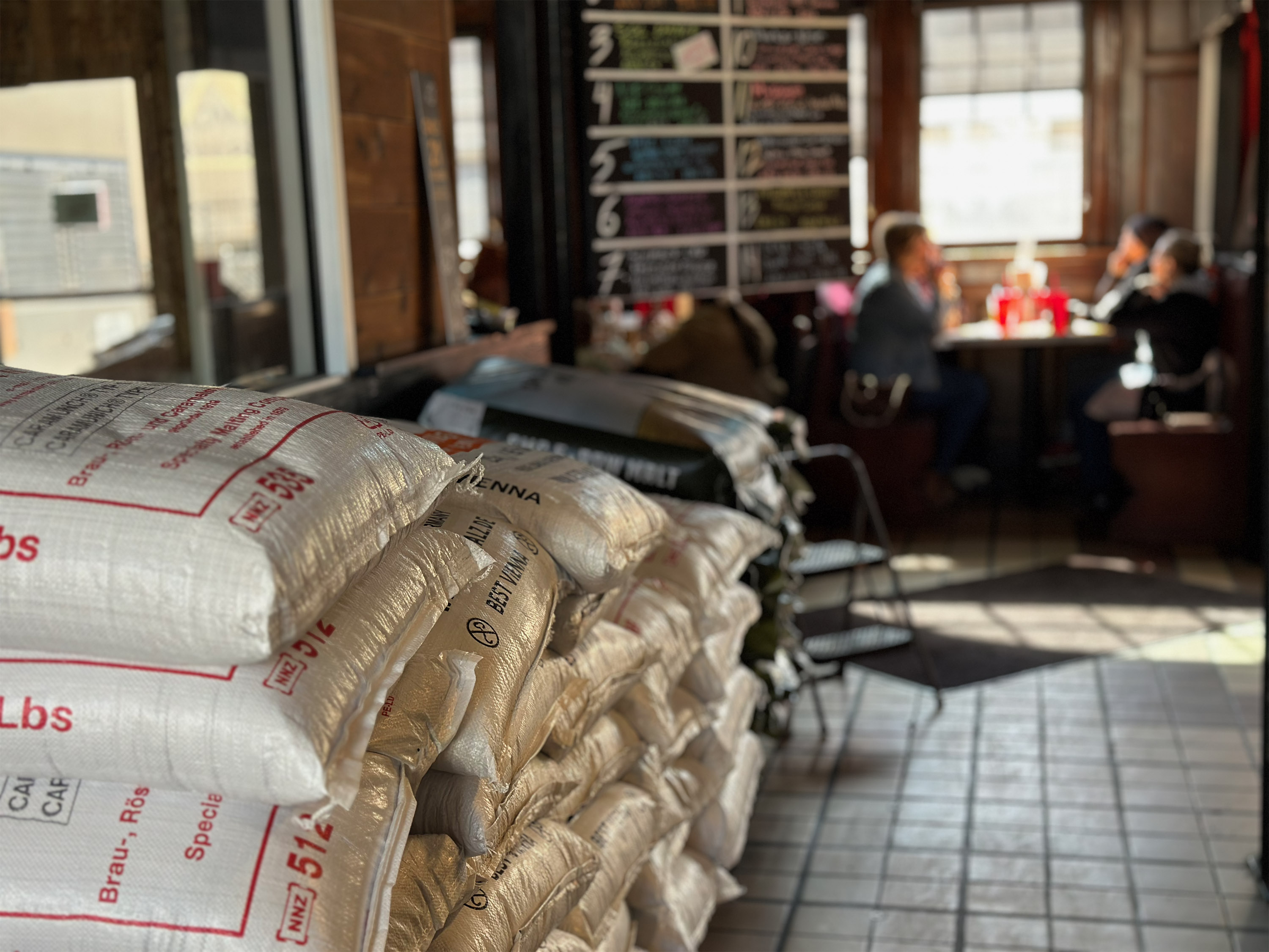 Stacked sacks of Vienna Malt greet visitors to Accomplice Beer Company's Cheyenne taproom. Photo Credit: Amber Leberman