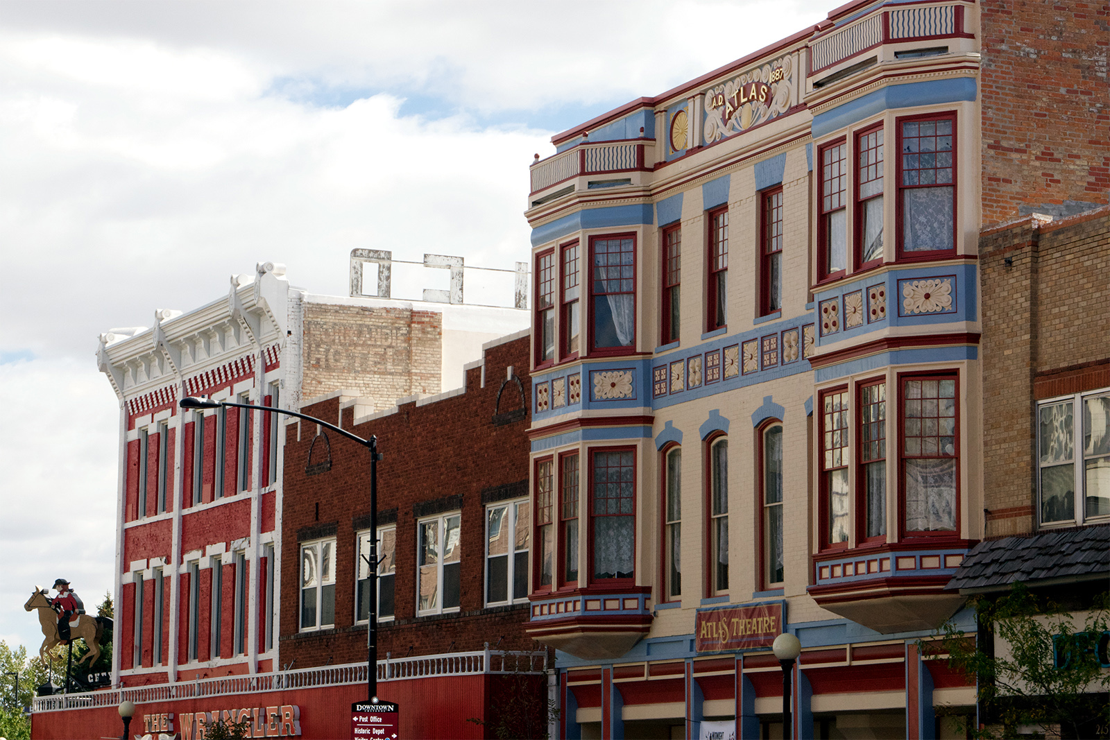 Cheyenne's walkable downtown features historic buildings bearing vintage advertisements and innovative craft beer and spirits purveyors. Pedestrians can carry open containers of beer and wine between live music venues, art galleries and cultural institutions such as the Atlas Theater. Photo Credit: Amber Leberman