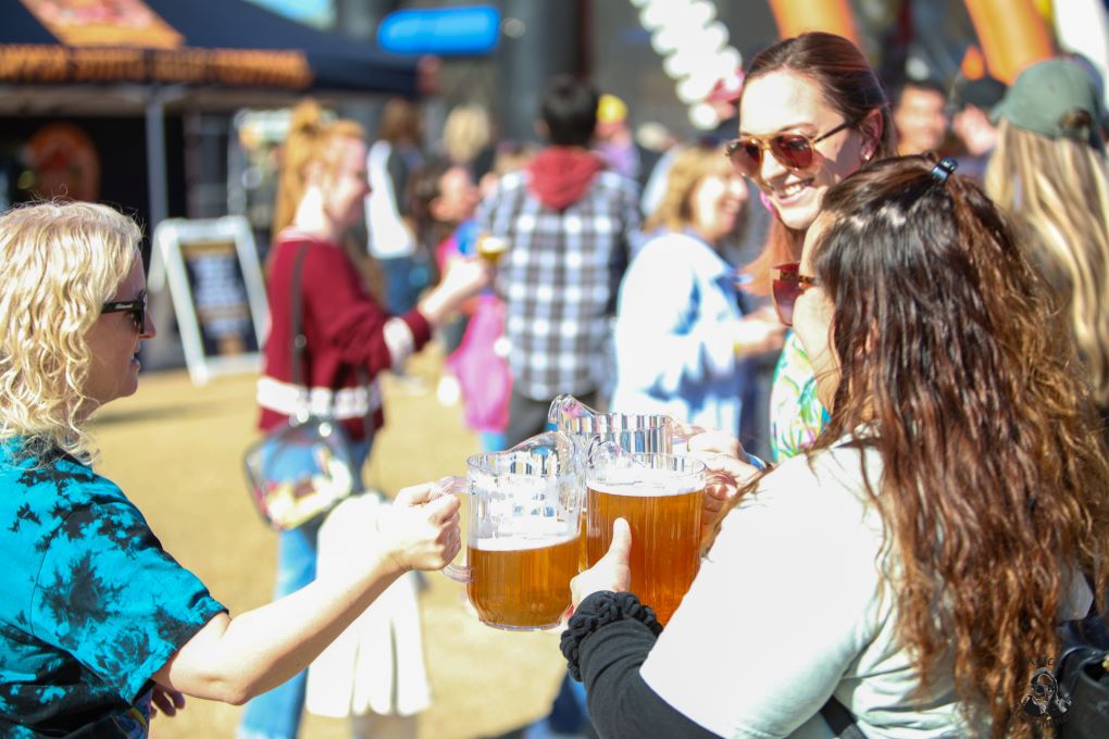 The Beer Babes Family pouring their Bone Haus collab Babe Brew Cream Ale at Copper State Beer Festival, credit Mosca Montgomery