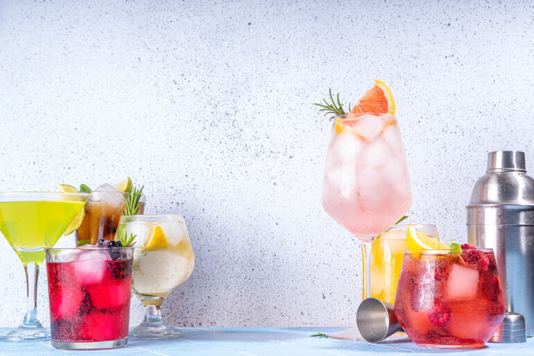 Assorted colorful functional beverages with ice and fresh fruit garnishes